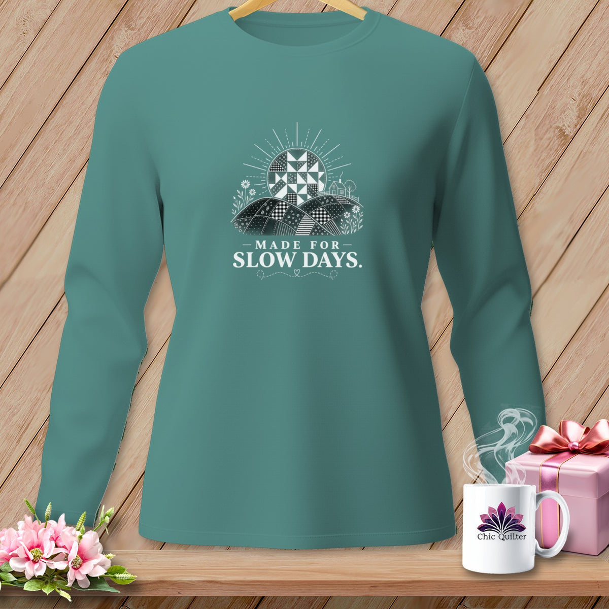 Teal long-sleeve shirt with "Made for Slow Days" text and a quilt sun graphic.