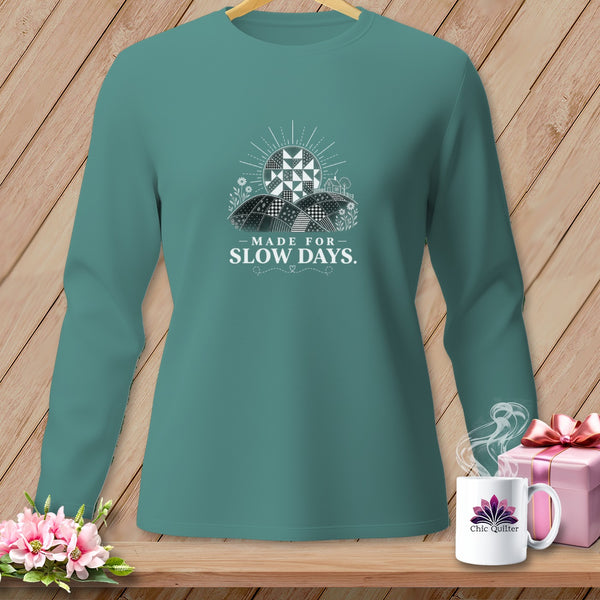 Teal long-sleeve shirt with "Made for Slow Days" text and a quilt sun graphic.