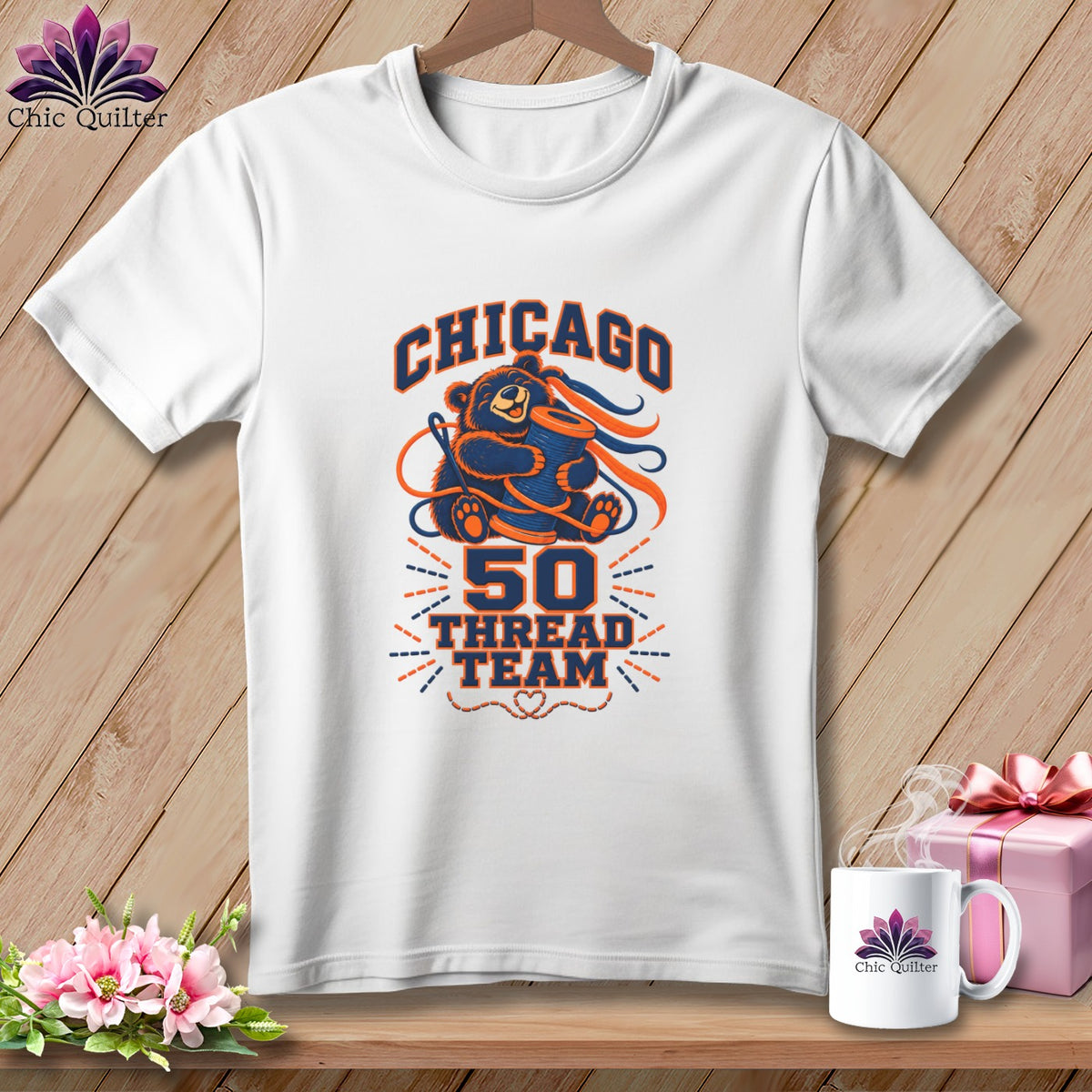 A white t-shirt features a graphic with a bear holding a spool of thread and the text Chicago 50 Thread Team.