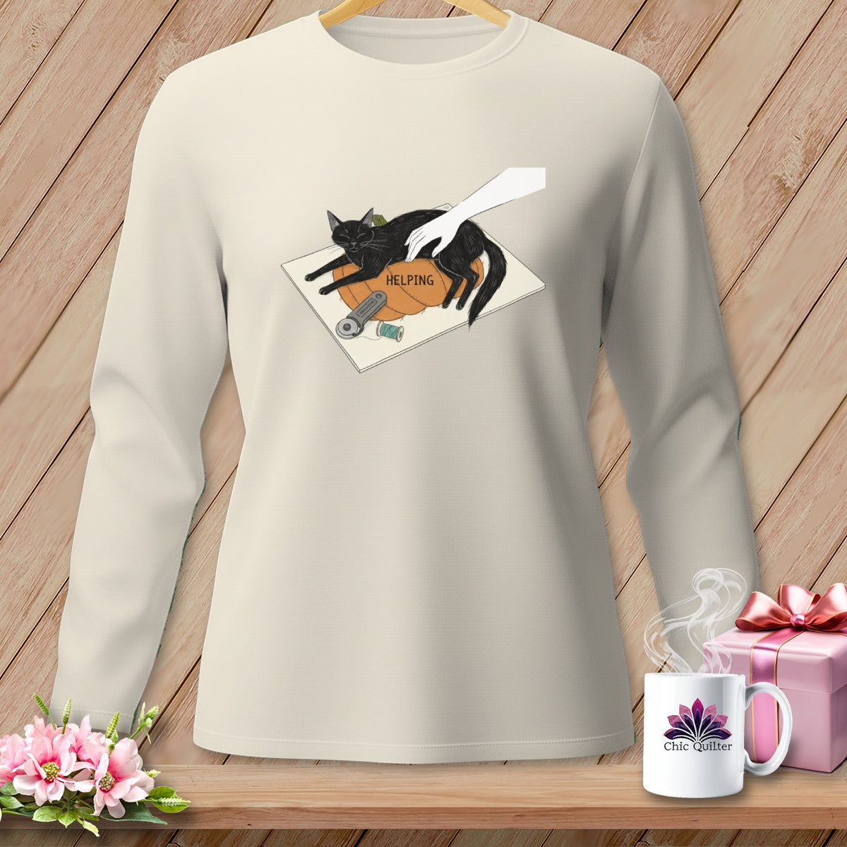 Cream sweatshirt with graphic of cat on pumpkin with sewing supplies and text "HELPING".