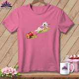 A pink short-sleeved t-shirt featuring a graphic of a girl tightrope walking on red thread.