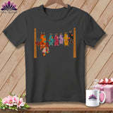 T-shirt graphic of colorful, patchwork bats hanging upside down on a clothesline.