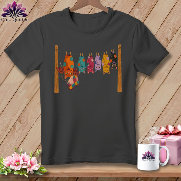 T-shirt graphic of colorful, patchwork bats hanging upside down on a clothesline.