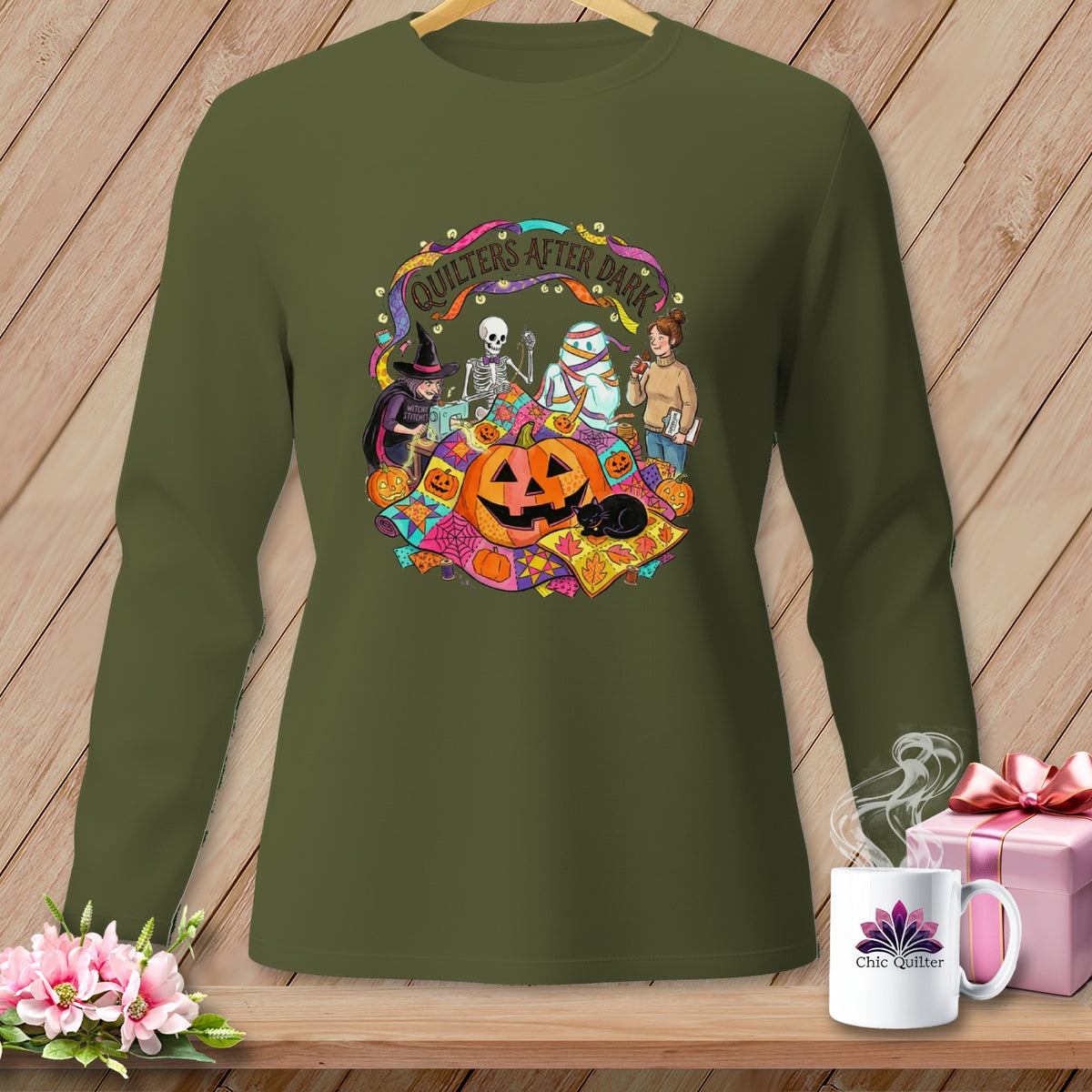 Green long-sleeve shirt with Halloween quilting graphic and text "Quilters After Dark".