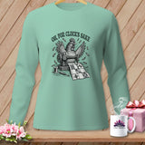 Mint long-sleeve shirt with a graphic of a chicken sewing a quilt, text 