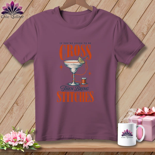 Purple t-shirt with "If you're going to be cross, then bring stitches" text and martini glass.