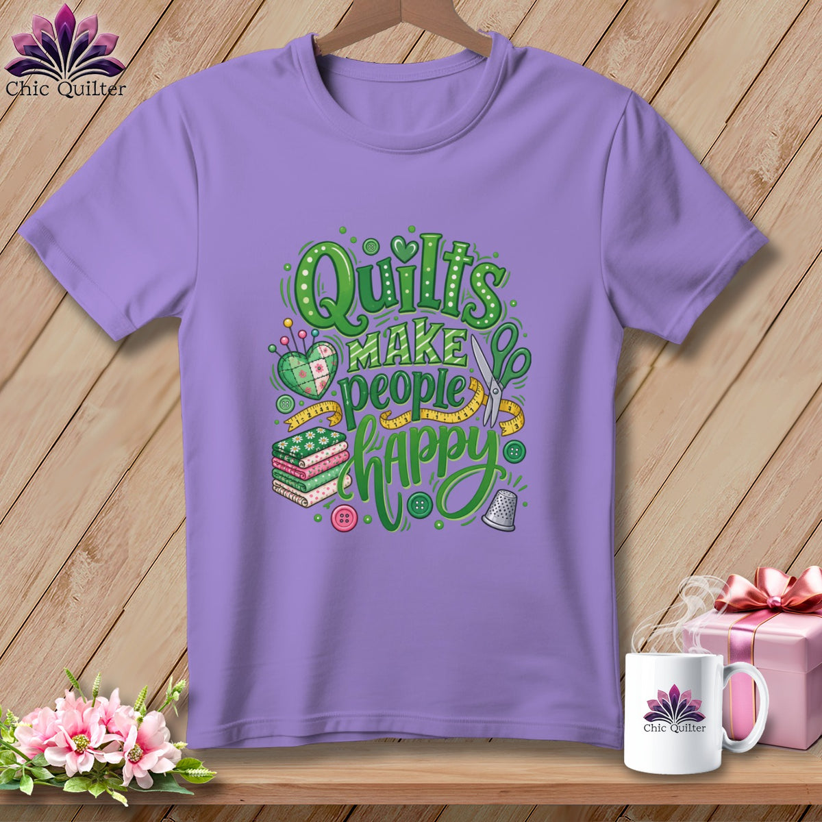 Purple t-shirt featuring the green text Quilts Make People Happy, surrounded by sewing-themed illustrations.