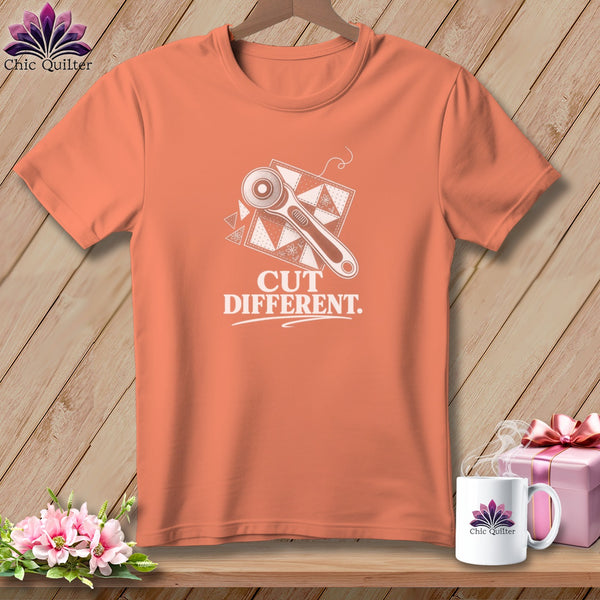 Orange t-shirt with rotary cutter graphic and "CUT DIFFERENT." text.