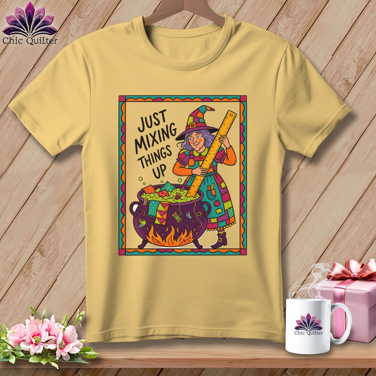 Yellow t-shirt with witch illustration and text "Just Mixing Things Up".