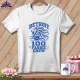 A white crewneck t-shirt featuring a blue graphic of a roaring lion, a thread spool, and text reading 