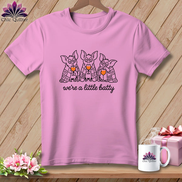 Pink t-shirt with three bats holding wine glasses, text "we're a little batty".