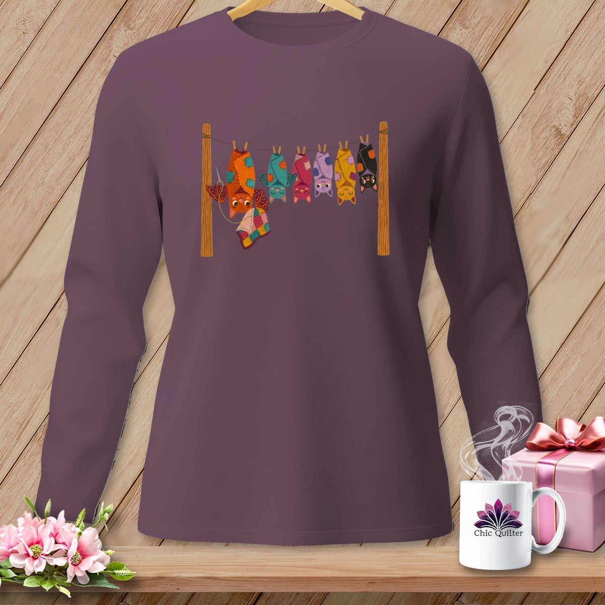 Long-sleeve shirt with colorful patchwork bats hanging on a clothesline.