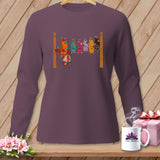 Long-sleeve shirt with colorful patchwork bats hanging on a clothesline.