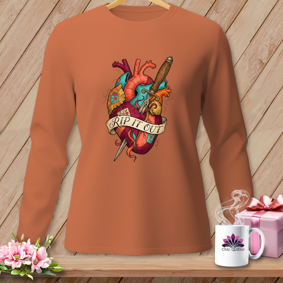 Long sleeve shirt with a dagger through a heart graphic that says "Rip It Out".