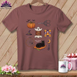 T-shirt with Halloween-themed sewing illustrations: pumpkin, ghost, scissors, cat, and spiderweb.