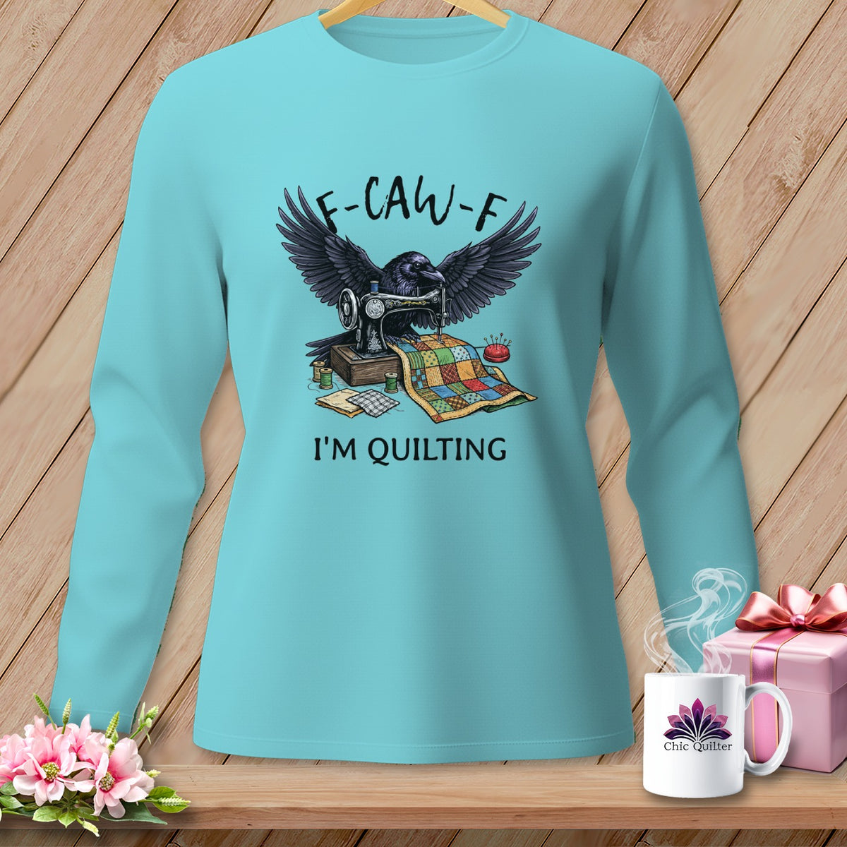 Raven with wings spread over sewing machine and quilt, text reads "F-CAW-F I'M QUILTING".