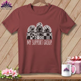T-shirt with three women's faces peeking over a quilt, reading 