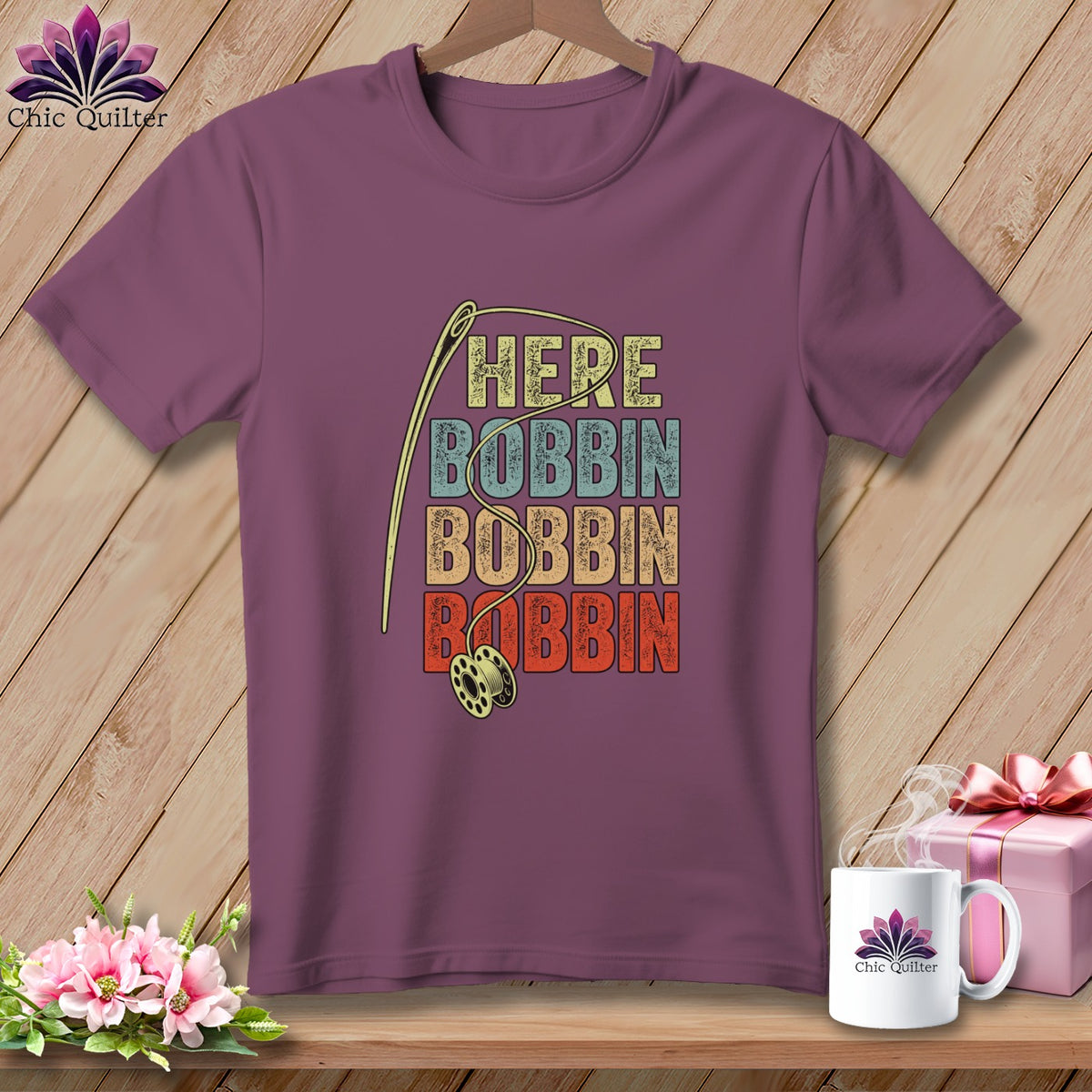 Purple t-shirt with "HERE BOBBIN BOBBIN BOBBIN" text and sewing needle.