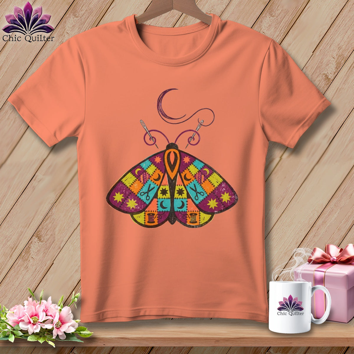 Peach t-shirt with patchwork moth design, crescent moon, and sewing supplies.