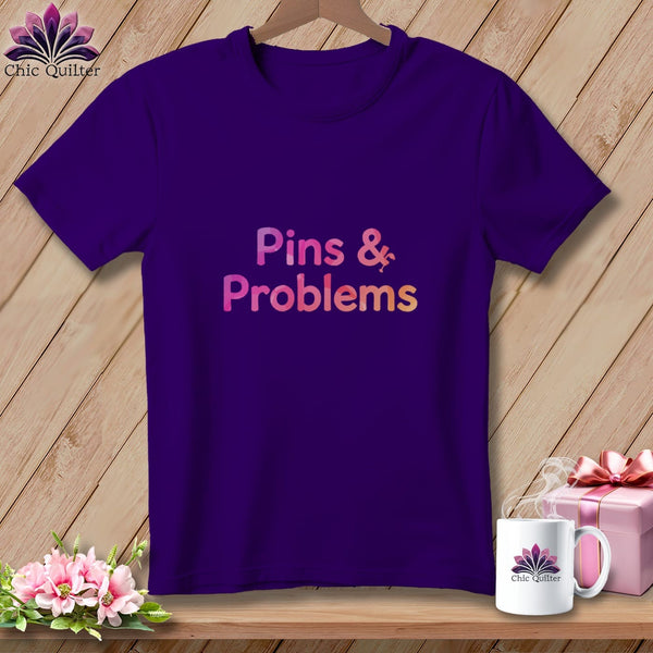 Purple t-shirt with "Pins & Problems" text and lightning bolt graphic.