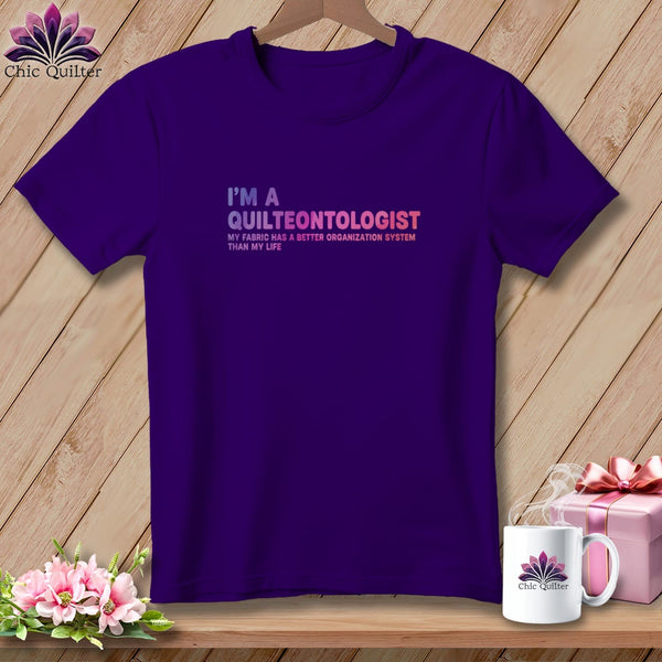 Purple t-shirt with "I'm a quilteontologist" text and a lotus logo.