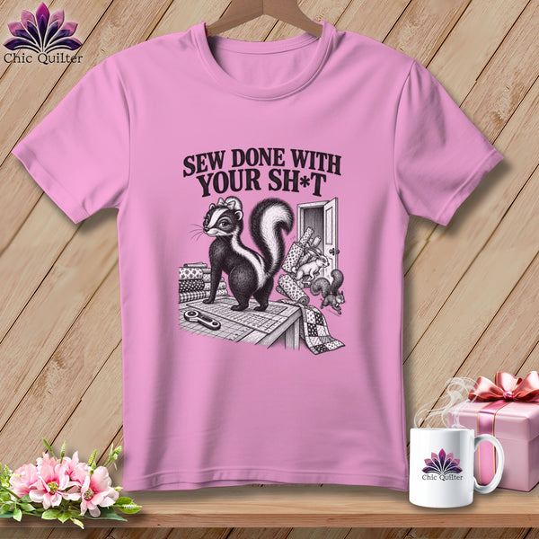 Pink t-shirt with a skunk, fabric, and "Sew Done With Your Sh*t" text.