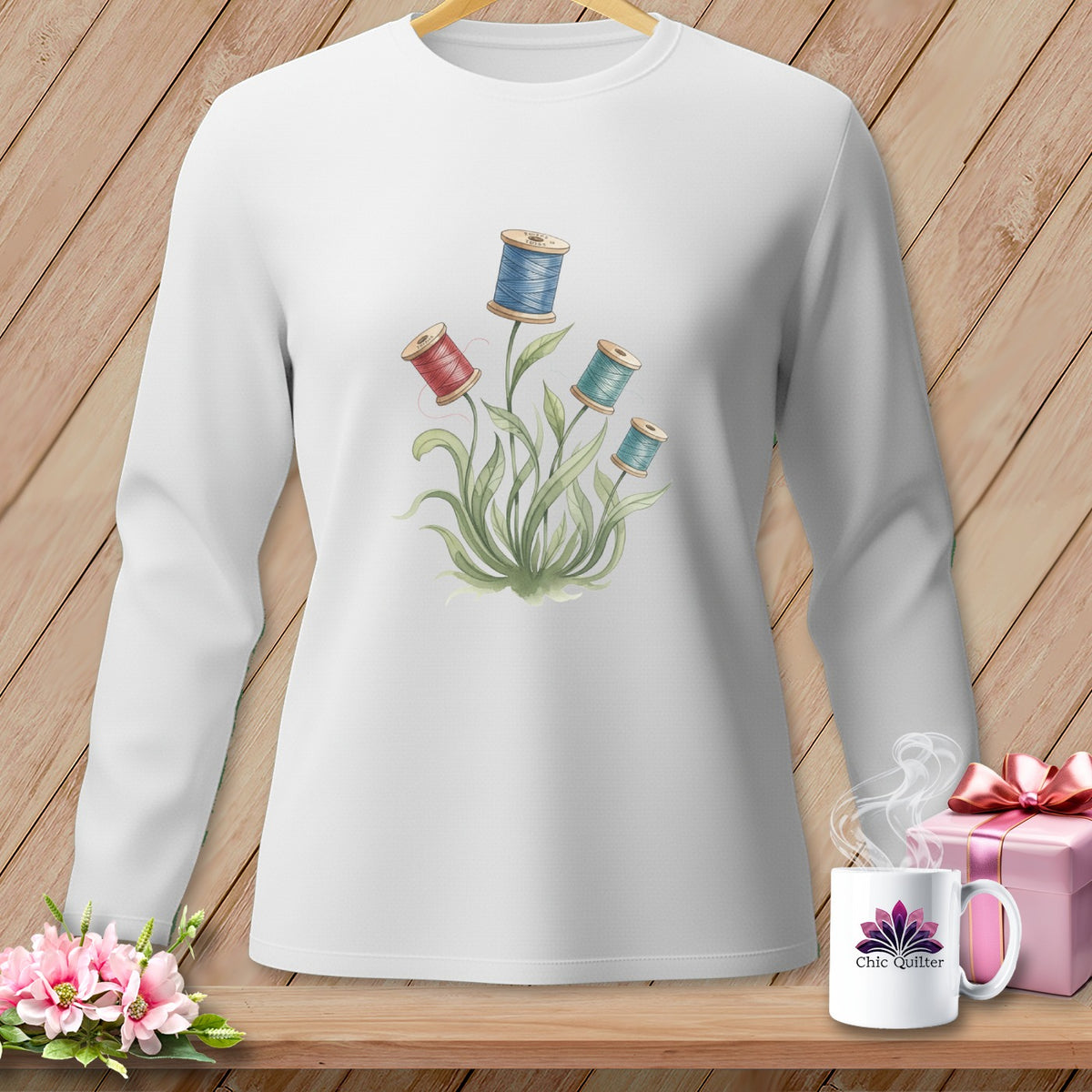 White long-sleeve shirt with floral spool of thread graphic and "Chic Quilter" mug.