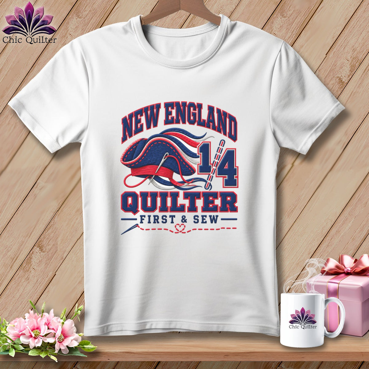 White t-shirt with a blue and red graphic featuring the text New England Quilter 14.