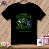 A black t-shirt featuring a green and blue graphic with the text Seattle Quilter.