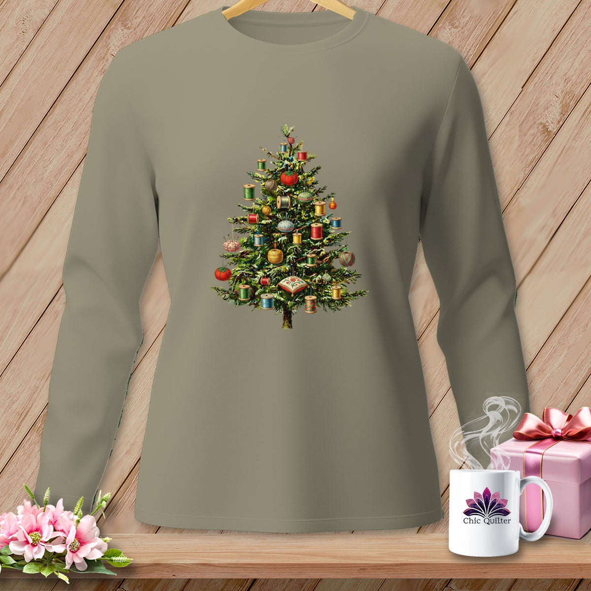 Long-sleeved grey shirt with a Christmas tree decorated with spools of thread.