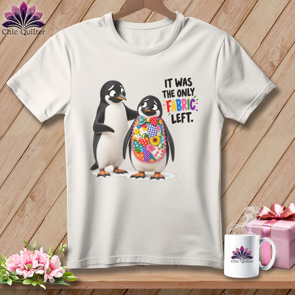 Two penguins on a t-shirt, one wearing a colorful patchwork bib, with text.