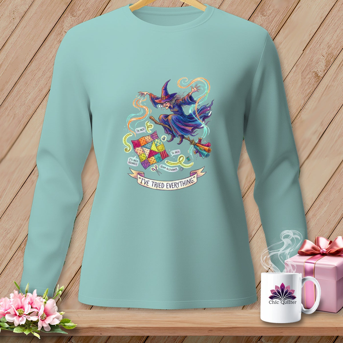 Light blue long-sleeve shirt with a witch sewing graphic and text "I'VE TRIED EVERYTHING."