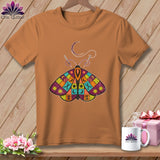 Orange t-shirt with a patchwork butterfly design featuring sewing notions.