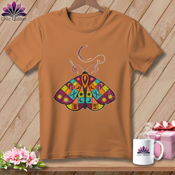 Orange t-shirt with a patchwork butterfly design featuring sewing notions.