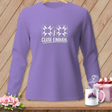 Lavender long sleeve shirt with quilting blocks and seam ripper graphic.