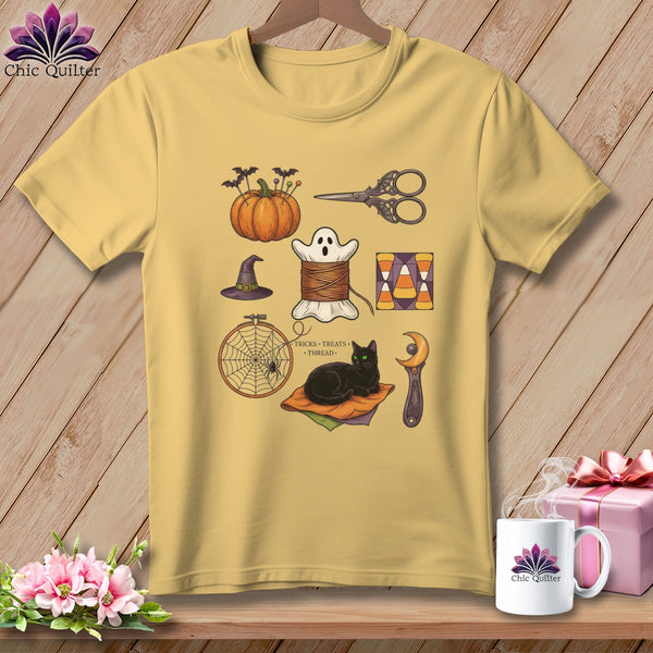 Yellow t-shirt with Halloween-themed sewing illustrations including a pumpkin, ghost spool, and black cat.