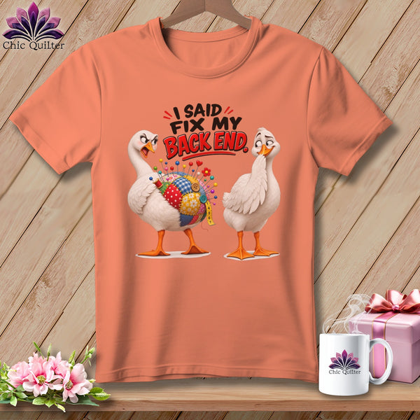 Peach t-shirt with cartoon geese and text "I SAID FIX MY BACK END."