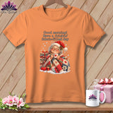 An orange t-shirt displays an illustrated graphic of an elderly woman holding a mug with text above her reading Good morning! Have a frickin fabric filled day.