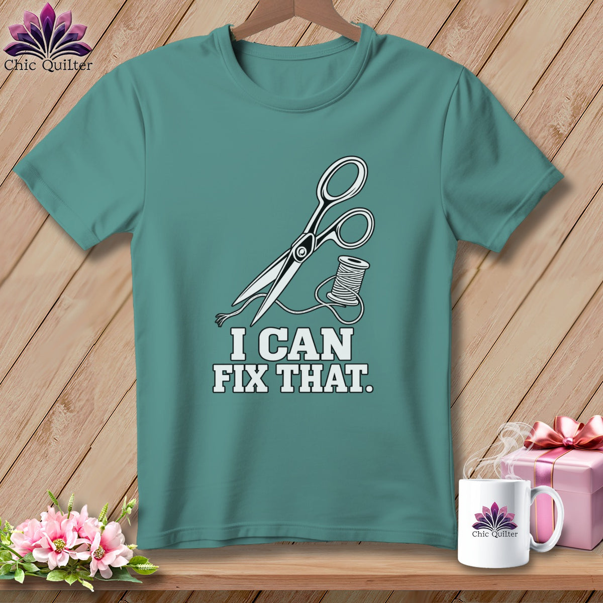Teal t-shirt with graphic of scissors, thread, and text "I CAN FIX THAT."