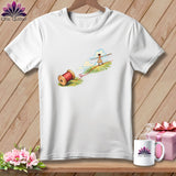 A white t-shirt features an illustration of a child tightrope walking on red thread extending from a spool.