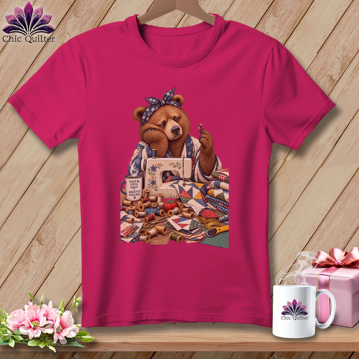 Bear sewing with fabric, thread spools, and a mug that says "Fueled by coffee, fabric, unrealistic deadlines."