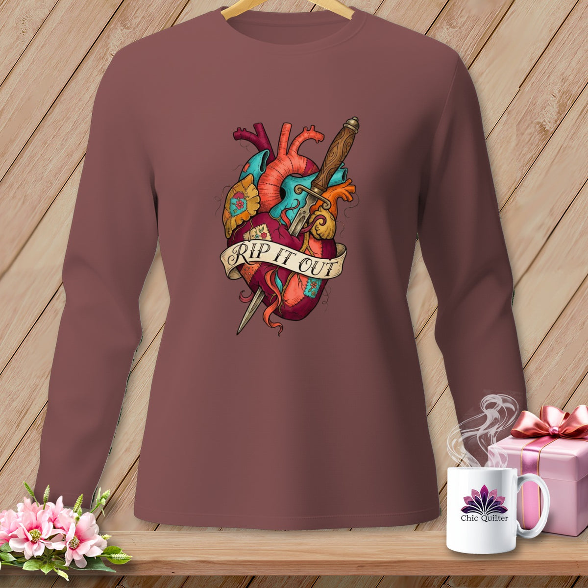 Long-sleeved shirt with anatomical heart and dagger graphic with "RIP IT OUT" text.