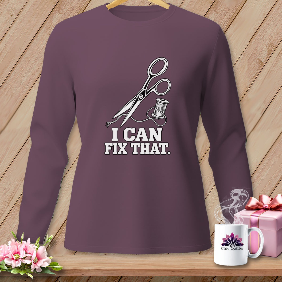 Plum long-sleeve shirt with scissors, thread, and "I CAN FIX THAT." text.