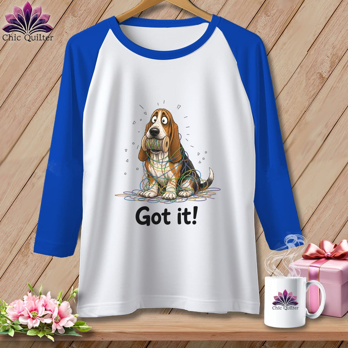 White raglan shirt with a basset hound tangled in colorful yarn and the text "Got it!".