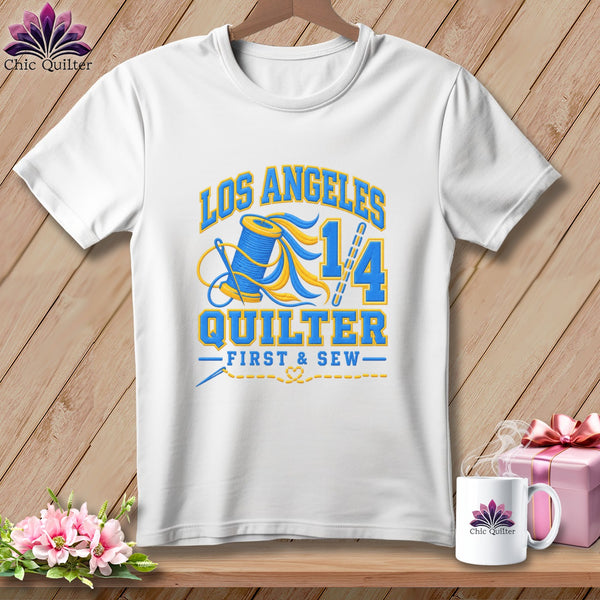 A white crewneck t-shirt featuring a blue and yellow quilting graphic with the text Los Angeles Quilter.