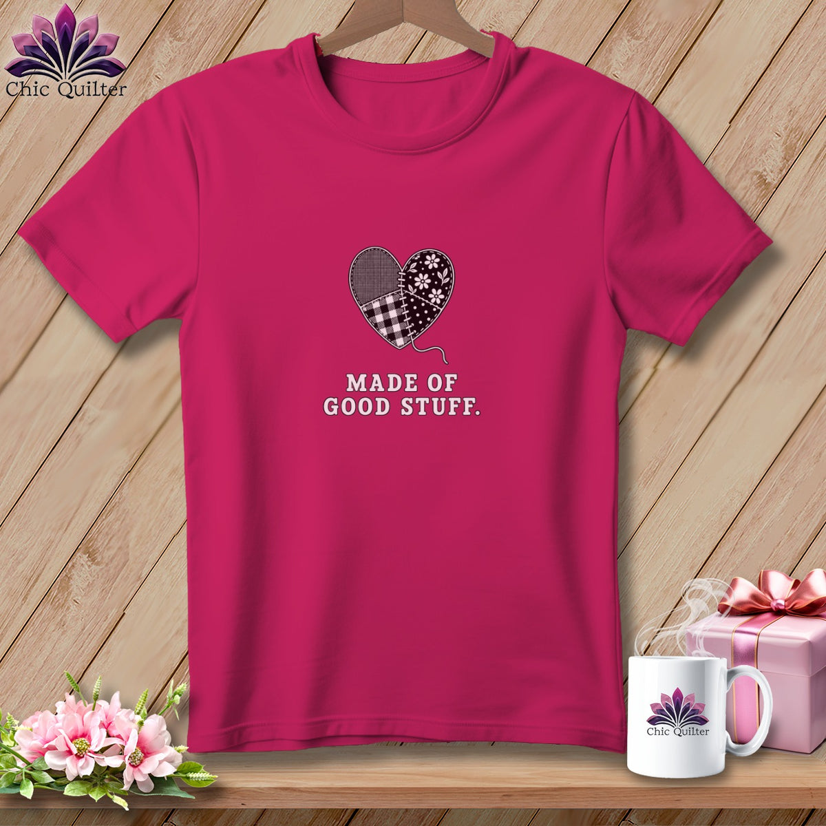 Pink t-shirt with a patchwork heart graphic and text "MADE OF GOOD STUFF."
