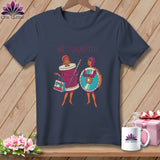 T-shirt graphic of two cartoon women, one with a spool of thread, the other with a saw.