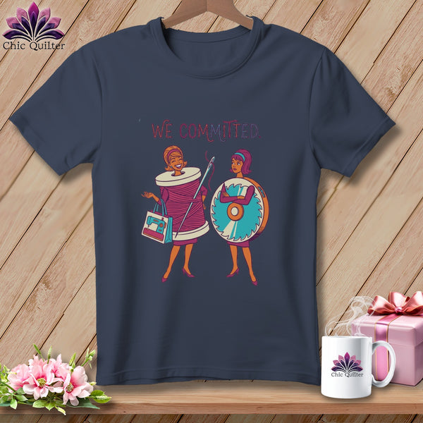 T-shirt graphic of two cartoon women, one with a spool of thread, the other with a saw.
