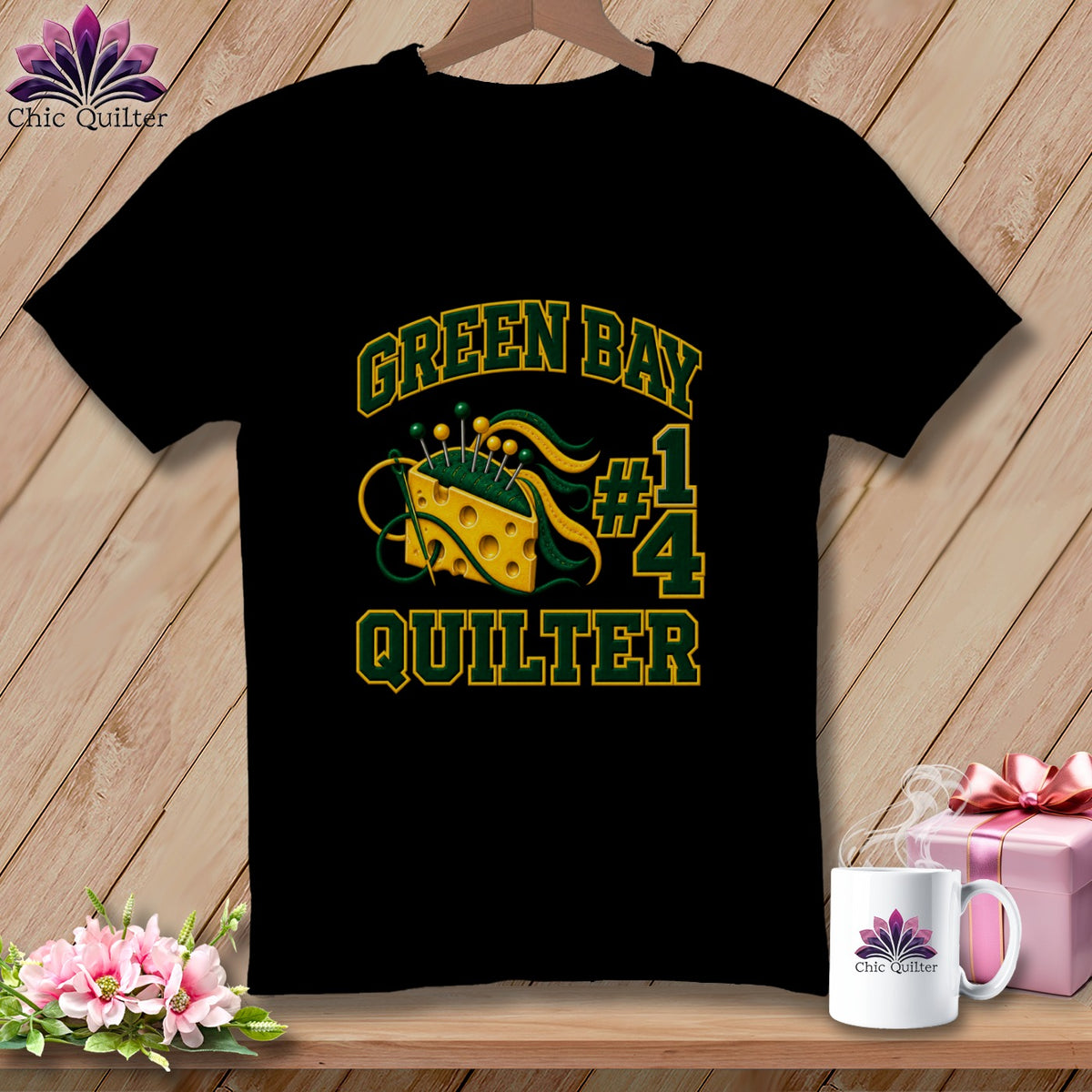 A black t-shirt features Green Bay Quilter text alongside a Swiss cheese pin cushion graphic.