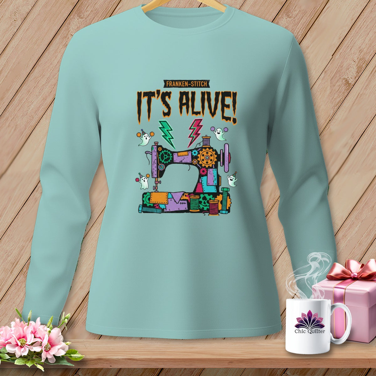 Light blue long-sleeve shirt with Frankenstein sewing machine and "It's Alive!" text.
